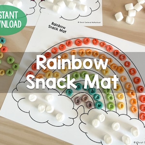 May include: Printable rainbow snack mat with a rainbow arc made of cereal rings and clouds made of marshmallows. The text "Rainbow Snack Mat" is printed on the mat.