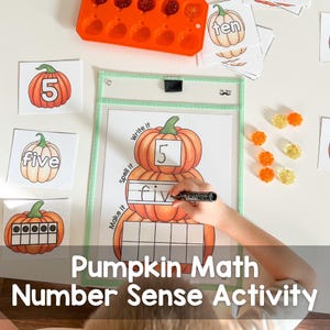 May include: A child's hand writes the word "five" on a worksheet with a stack of three pumpkins. The worksheet has the words "Make it", "Spell it", and "Write it" on the side. The pumpkins have the number "5" written on them. There are also orange and yellow gummy candies on the table.