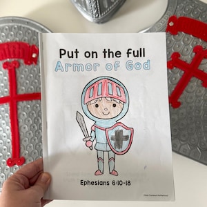 May include: A white booklet titled Put on the full Armor of God with a hand-coloured illustration of a knight holding a sword and shield. The cover features the text Ephesians 6:10-18 and Christ-Centered Motherhood at the bottom corner.