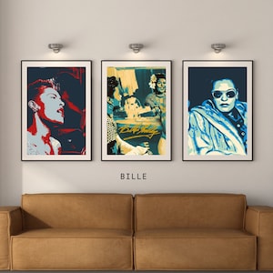 Puede incluir: Tres impresiones de arte enmarcadas con Billie Holiday. Las impresiones son de estilo minimalista con un esquema de color azul, rojo y amarillo. Las impresiones están colgadas en una pared blanca sobre un sofá de cuero marrón.