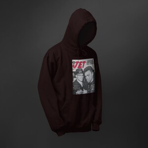 May include: A maroon hoodie with a vintage Jet magazine cover featuring a black and white photo of two men. The magazine cover has the text "JET" in red letters.