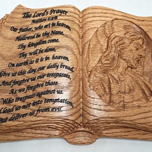 Carved Bible of The Lord's Prayer on left, silhouette of Christ on other. Made of Solid Oak wood with keyhole. Bible engraved, NOT lasered.