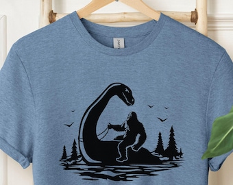 Bigfoot Riding Nessie Shirt, Cryptidcore Loch Ness Monster Hiking Camping Sweater, Father&#39;s Day Gift, Funny Yeti Sasquatch Mountain T-Shirt