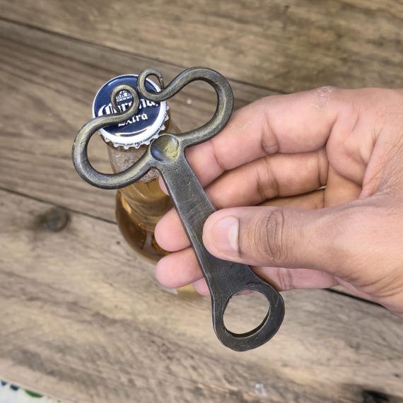 A real blacksmith hammered this from steel — the forged texture and Viking silhouette make it look like a prop from a saga, not a gift-shop trinket.