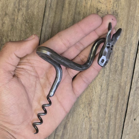 A blacksmith actually hammer-forged this corkscrew from raw iron — it's a functional barware piece with visible hand-craft marks that no factory could replicate.