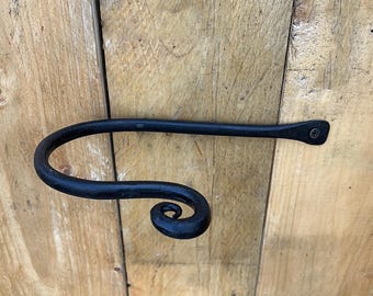May include: Black metal wall mounted towel rack with a decorative scroll design.