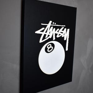 May include: Black and white canvas print featuring the Stussy logo and a white 8-ball.