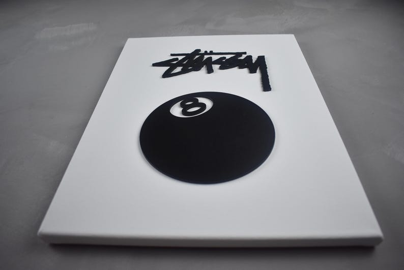 May include: White canvas with a black 8-ball and the word "STUSSY" in black lettering.
