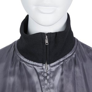 May include: A close-up of a grey bomber jacket with a black ribbed collar. The jacket has a silver zip running down the front. The jacket is displayed on a mannequin.