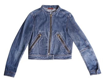 May include: A blue denim jacket with a zipper closure and multiple pockets. The jacket has a stand-up collar and long sleeves.