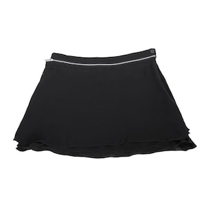 May include: A black skirt with a zipper detail at the waist and a layered ruffle hem.