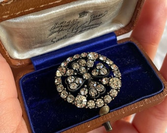 May include: A vintage brooch with a silver setting and a large cluster of clear rhinestones in a floral design. The brooch is in a blue velvet box with a label that reads "S.H. & Co. Blackheath London."