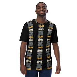 May include: Black t-shirt with a geometric pattern in gold and white. The pattern is made up of repeating shapes and lines.