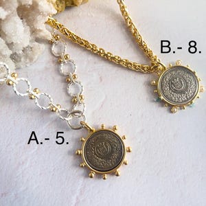 May include: Two gold necklaces with silver chain links and coin pendants. The coin pendants have a silver finish with a raised design. The necklace on the left is labeled "A. - 5." and the necklace on the right is labeled "B. - 8."