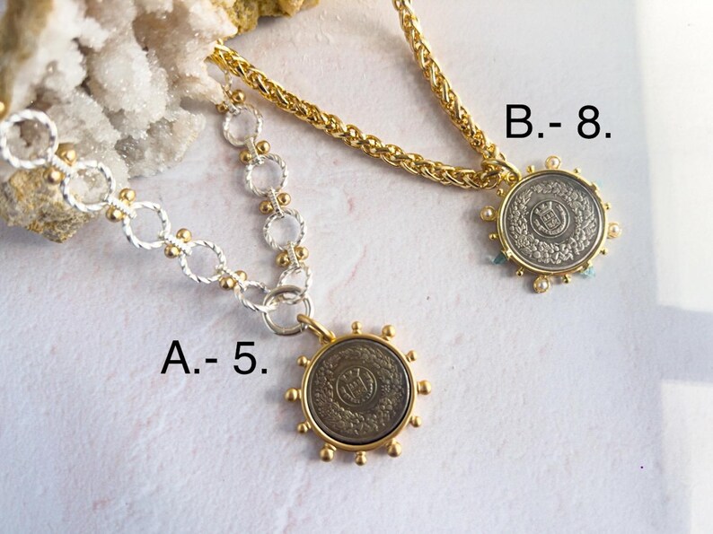 May include: Two gold necklaces with silver chain links and coin pendants. The coin pendants have a silver finish with a raised design. The necklace on the left is labeled "A. - 5." and the necklace on the right is labeled "B. - 8."