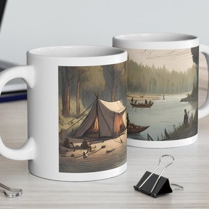 May include: White ceramic mug with a forest scene featuring a campsite with a tent, a campfire, and people in boats on a river. The scene is painted in a muted color palette.