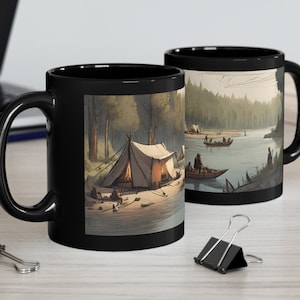 May include: Two black coffee mugs with a forest scene and a campsite with a tent. One mug shows a river with people in a canoe. The other mug shows a tent with a campfire.