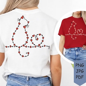 May include: White t-shirt featuring a black cat design outlined with red hearts. The cat is sitting on a curved line with small black dots. A red t-shirt with the same design is also shown.