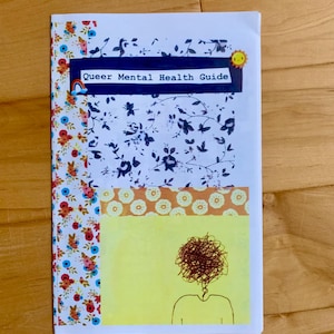 May include: A guide titled "Queer Mental Health Guide" with a rainbow and a sun sticker. The cover features a yellow background with a black and white illustration of a person with a messy head of hair.