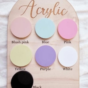 May include: A wooden board with the word "Acrylic" written on it. There are eight round acrylic circles in different colors: blush pink, blue, pink, yellow, purple, white, and black.