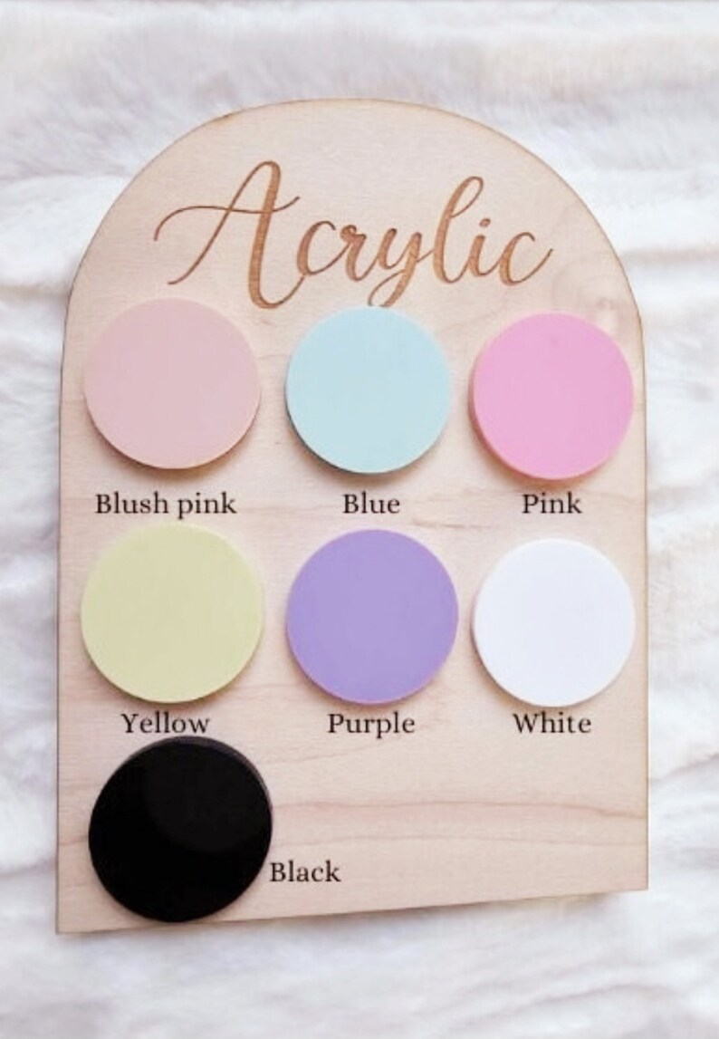 May include: A wooden board with the word "Acrylic" written on it. There are eight round acrylic circles in different colors: blush pink, blue, pink, yellow, purple, white, and black.