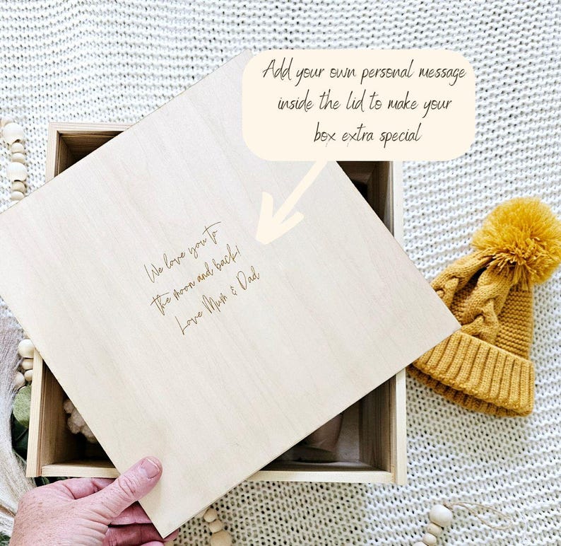 May include: A wooden box with a lid that can be personalized with a message. The lid is open and the inside of the box is empty. The lid has the text "We love you to the moon and back! Love Mum & Dad" engraved on it.