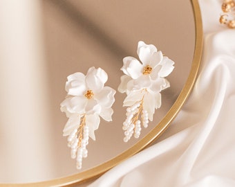 Wedding earrings for the bride with white flowers for a wedding dress