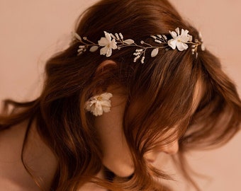 Statement bridal vine, headpiece with flowers, leaves, and crystals.  Gold, silver, and rose gold colors, for the wedding dress of the bride