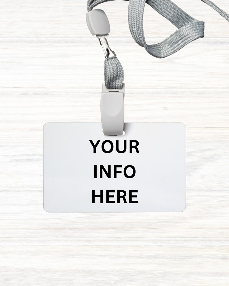 May include: A white plastic badge holder with a gray lanyard. The badge holder has the text "YOUR INFO HERE" printed on it.