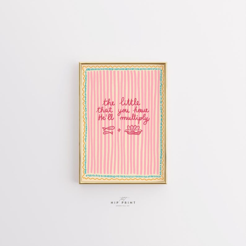 May include: A framed art print with a pink striped background and the text "the little that you have He'll multiply." The artwork includes illustrations of fish and loaves of bread. The frame is gold with a teal border.