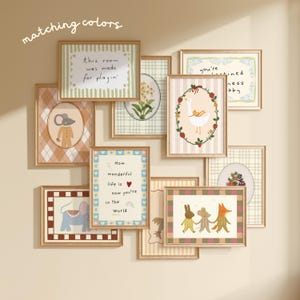 May include: A collection of framed art prints with whimsical illustrations and quotes. The prints feature a variety of designs, including animals, floral patterns, and inspirational text. The color palette includes soft pastels and earth tones, creating a cohesive and charming aesthetic.