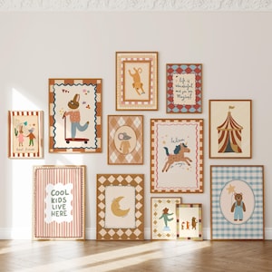 May include: A collection of framed art prints with whimsical illustrations. The prints feature animals, circus themes, and inspirational quotes in a variety of colors, including brown, pink, and blue. The frames are a warm brown color.