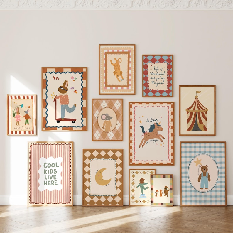 May include: A collection of framed art prints with whimsical illustrations. The prints feature animals, circus themes, and inspirational quotes in a variety of colors, including brown, pink, and blue. The frames are a warm brown color.
