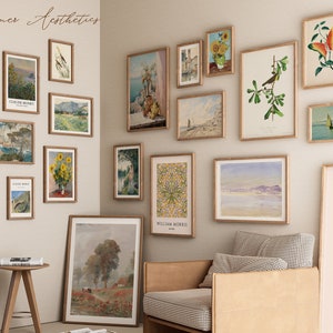 May include: A gallery wall featuring a selection of framed prints, showcasing landscapes, still lifes, and botanical illustrations. The prints are arranged symmetrically on a pale beige wall. The wall is decorated with a variety of framed prints, including landscapes, still lifes, and botanical illustrations. The prints are arranged in a symmetrical pattern on a pale beige wall.