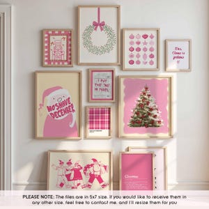 May include: A collection of framed Christmas-themed art prints in pink and beige. The prints feature a wreath, ornaments, a Christmas tree, Santa Claus, and text that reads "No Shave December" and "Mrs. Claus is jealous."
