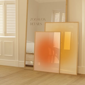 May include: Two framed abstract art prints with a gradient colour scheme. The larger print is a yellow to orange gradient, and the smaller print is a red to orange gradient. The text "ZOOM ON DETAILS" is visible in the background.