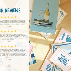 May include: A collection of framed art prints featuring illustrations of wine bottles, glasses, and inspirational quotes. The prints are in various colors, including blue, pink, and white, and are displayed on a wooden surface.