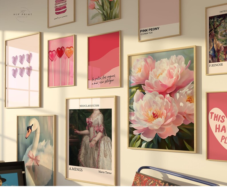 May include: A gallery wall with various framed prints, including a pink peony floral print, a print with the text "This Has Place", a print with the text "Pink Peony", a print with the text "Neoclassicism", a print with the text "bo pulser les vagues, a mar, on plonge", a print with a swan, a print with hearts, and a print with macarons.