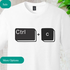May include: White t-shirt with a black graphic of computer keyboard keys that say "Ctrl + C".