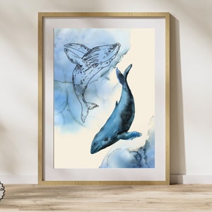 May include: A framed art print featuring two whales. One whale is a detailed blue watercolor, the other is a black outline. The background has blue watercolor washes. The frame is a light wood color. The words "DIGITAL DOWNLOAD" are in the bottom left corner.
