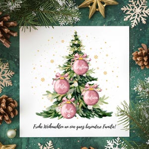 May include: A Christmas card featuring a watercolor illustration of a decorated Christmas tree with pink ornaments. Each ornament has a name on it. The card is surrounded by festive greenery and gold accents. The text "Frohe Weihnachten an eine ganz besondere Familie!" is at the bottom.