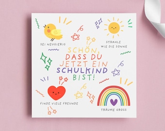 Op de afbeelding: Een vierkante wenskaart met kleurrijke illustraties en tekst. De kaart toont een gele vogel, een lachende zon, een regenboog en een rood hart. Tekst bevat "Wees nieuwsgierig", "Schijn als de zon" en "Vind veel vrienden".