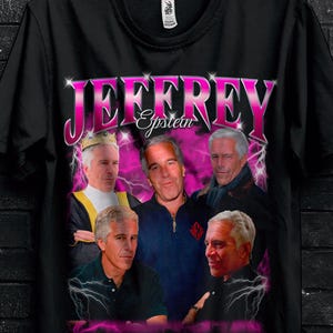 May include: Black t-shirt featuring a graphic of several men with the name "JEFFREY Epstein" in pink. The shirt includes promotional text and a butterfly graphic.