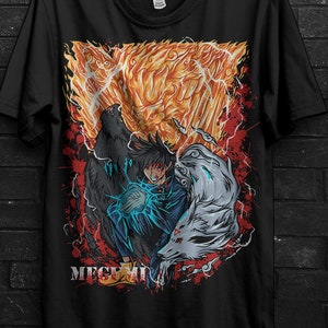 May include: Black t-shirt featuring a vibrant anime-style graphic with a central character and two spirit animals. The design includes fiery orange and red elements, with the word "MEGEMI" at the bottom. A gold and black circular promotion is visible.