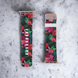 May include: A pink, green, and black floral patterned Apple Watch band with a rose gold buckle.