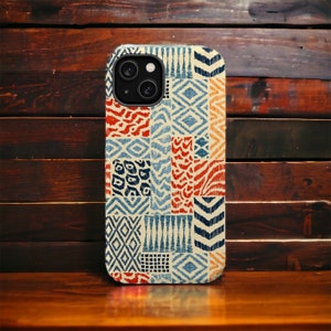 May include: A phone case with a colorful geometric pattern in shades of blue, red, and white. The case has a cutout for the camera lens.