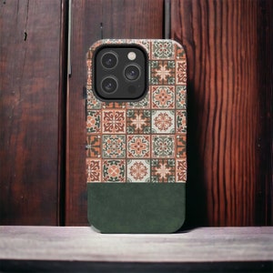 May include: A green and orange patterned phone case with a camera lens cutout. The case has a dark green bottom section.