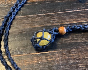 Adjustable hand-woven hemp necklace with a polished citrine gem.