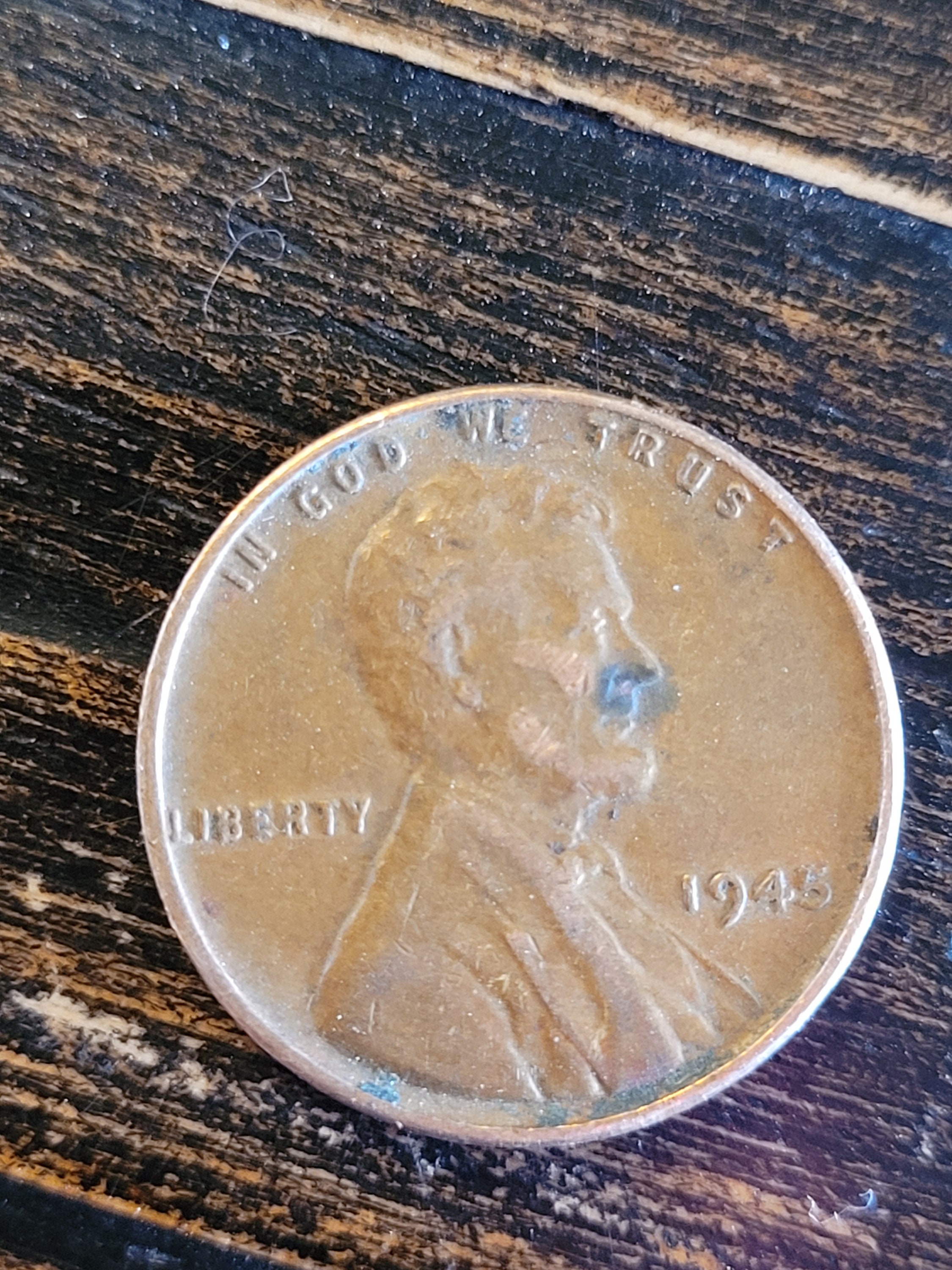 1945 wheat penny with no mark.  Mistake is the L on the ridge. Has been circulated.