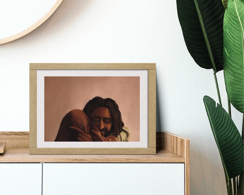 May include: A framed illustration of two people embracing. The background is a soft peach color. The people are depicted with dark skin and hair. The man has a beard and is wearing a light brown garment. The woman is wearing a dark brown garment.
